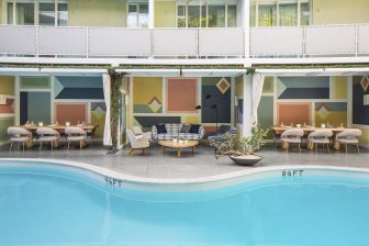 outdoor pool and dining area at Avalon Hotel Beverly Hills