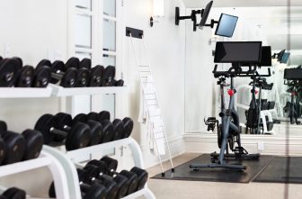Fitness room with dumbbells and Peloton bike