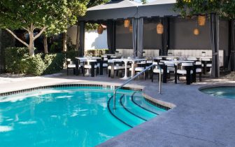 outdoor pool and dining area at Chi Chi Restaurant Palm Springs