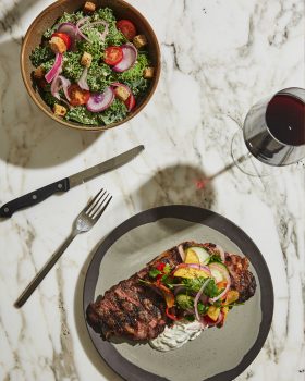 Overhead shot of GRILLED NEW YORK STRIP and salad